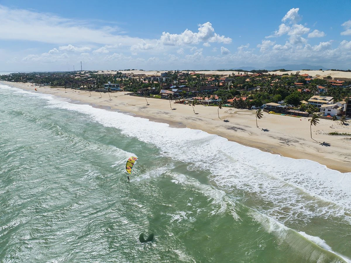 Fotografia real da praia e da orla de Cumbuco com um kitesurfista